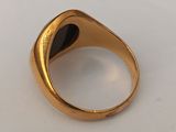 a close up of a gold ring on a white surface