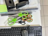 a keyboard, mouse, and other office supplies on a desk
