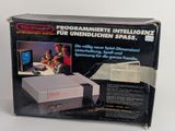 an old nintendo game console with a box and instructions on it