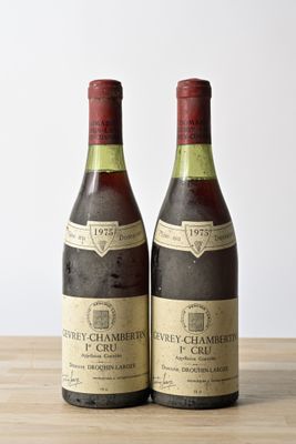 two bottles of wine sitting on top of a wooden table