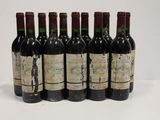 six bottles of wine are lined up in a row