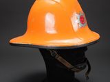 an orange hard hat on a black mannequin head