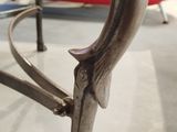 a close up of a metal chair with a glass top