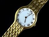 an image of a gold watch with roman numerals on a black background