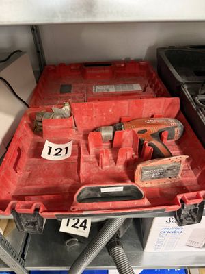 une boîte à outils rouge contenant des outils, posée sur une étagère