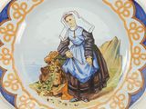a plate with a picture of a woman and a lion