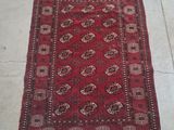 a red rug sitting on top of a floor next to a white floor