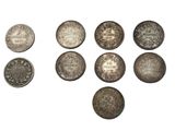 a close up of a bunch of coins on a white surface