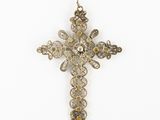 a close up of a cross on a chain on a white background