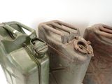 three gas cans sitting next to each other on the floor