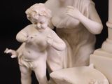 a statue of a woman and a child on a table