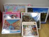 many puzzles on the table with pictures on them