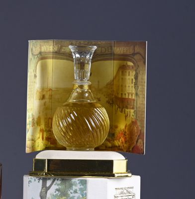 a bottle of perfume sitting on top of a box