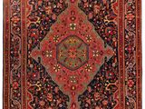 un tapis persan ancien aux couleurs rouge et noir