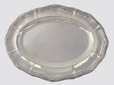 an oval silver plate on a white background with a silver rim