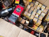 a cardboard box filled with assorted items on the floor