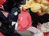 a pile of clothes that is sitting on the floor