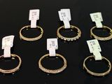 several gold rings with diamonds are on display in a store