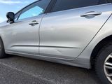 a silver car that is parked in a parking lot