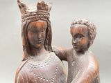 statue of a woman holding a child with a crown on her head