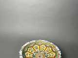 a small bowl sitting on a table with a gray background