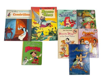 several children ' s books are lined up on a white surface