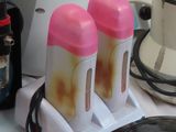 two bottles of liquid sitting on a counter next to a computer mouse