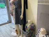 three mannequins in the corner of a clothing store