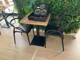 a small table with two chairs and a clock on it