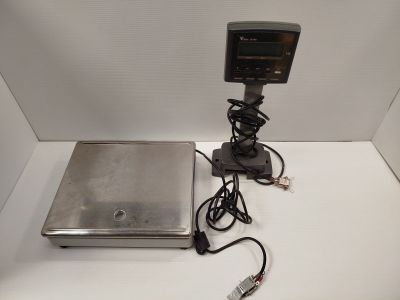 a laptop computer sitting on a table with a charger attached to it