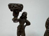 two figurines that are standing next to each other