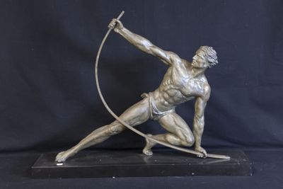 bronze statue of a man with a bow and arrow on a black background