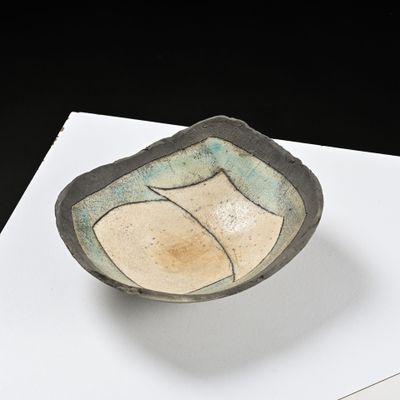 a small bowl sitting on top of a white table