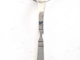 a silver spoon with a spoon handle on a white surface