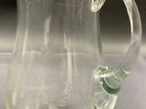 a glass pitcher that is sitting on a table