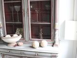 a china cabinet with a bowl on top of it