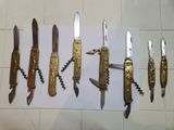 several different types of knives are lined up on a piece of paper