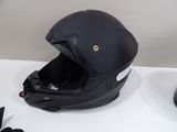a helmet on a table next to a pair of shoes