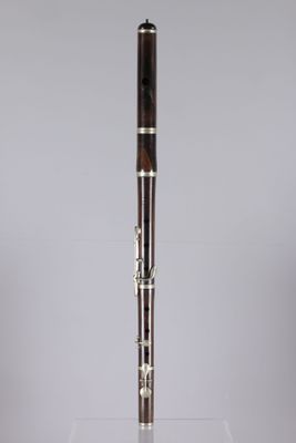 a close up of a wooden flute on a clear surface