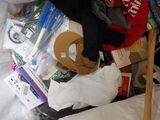 a bag full of items that are sitting on a bed