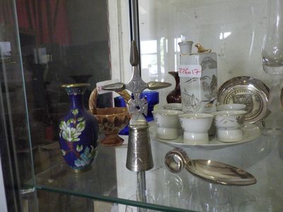 a glass display case with a lot of glass items on it