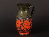a black and orange vase on a black background