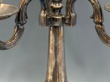 a silver candelab with three candles on it