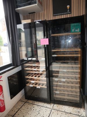 a wine cooler in the corner of a restaurant
