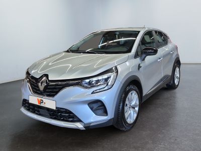 a silver car parked in a showroom with a black floor