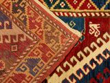 some very colorful rugs are stacked on top of each other
