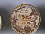 three small containers with decorative designs on them sitting on a table