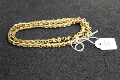 a close up of a gold chain with a tag on it