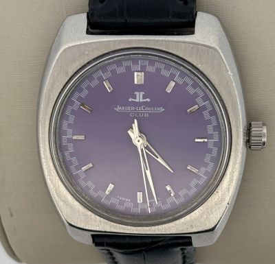 a close up of a wrist watch with a purple dial