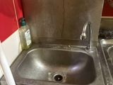 a sink in the corner of a small kitchen